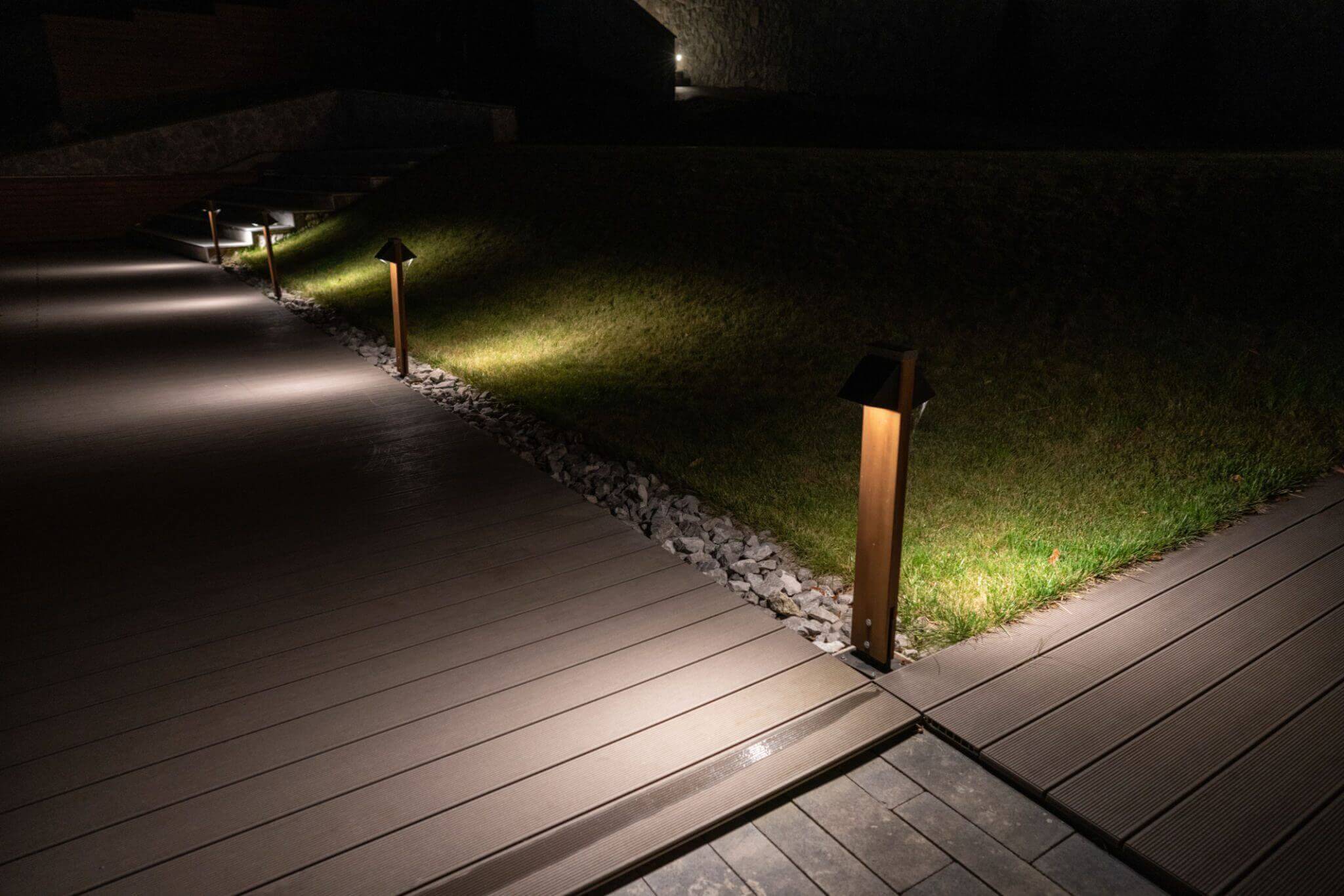Outdoor path lit by small garden lamps.